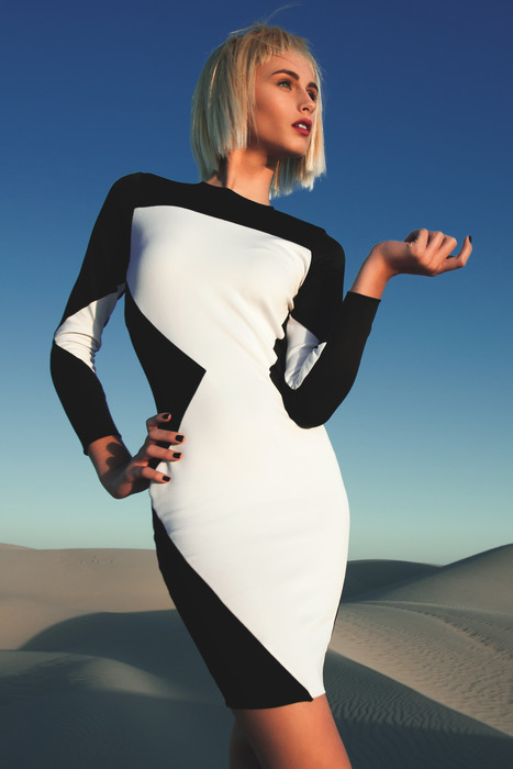 Graphic black-and-white fashion look styled in sculptural sand dunes
